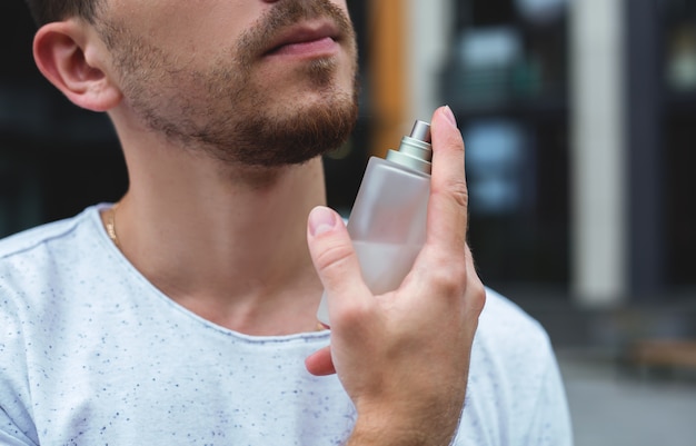 Man holding bottle of perfume