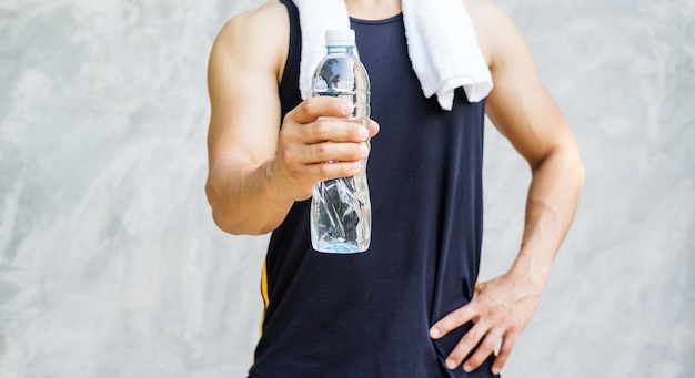 Man holding a bottle of water.