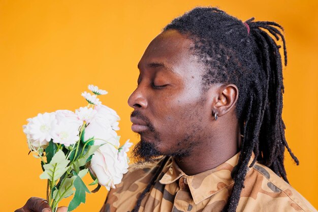 Man holding bouquet smelling roses person