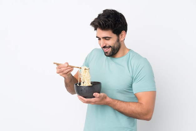 Man holding a bowl of noodles over isolated wall