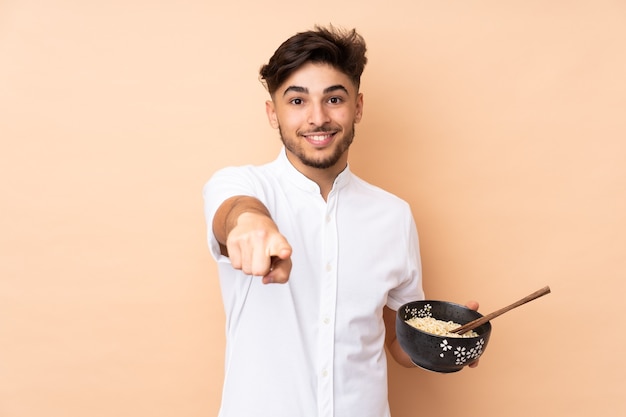 Man holding a bowl of noodles soup