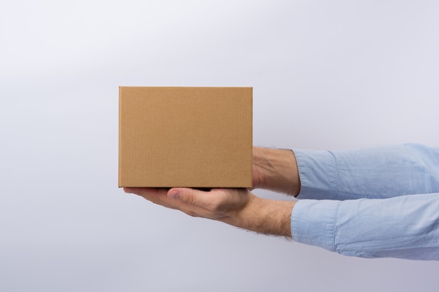 Man holding box at arm's length