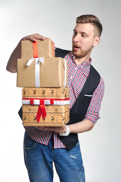 Man holding box with Christmas gifts in hands. 