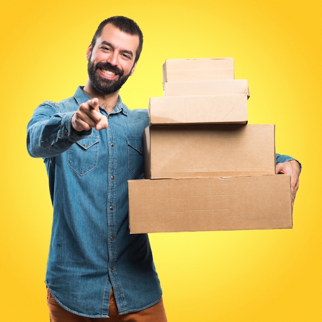 Man holding boxes on colorful background