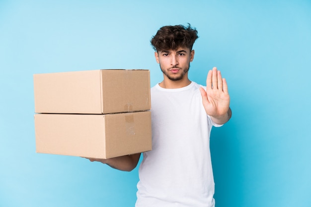 Man holding boxes showing stop sign