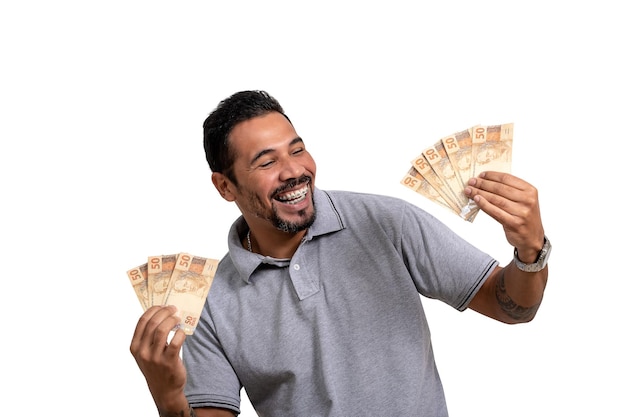 Мужчина держит бразильские деньги, улыбается