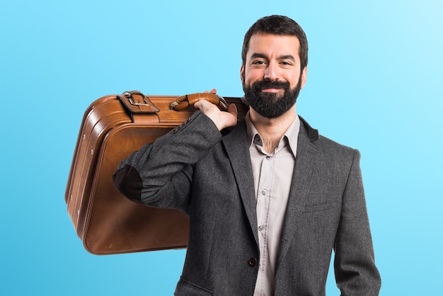 Man holding a briefcase on colorful background