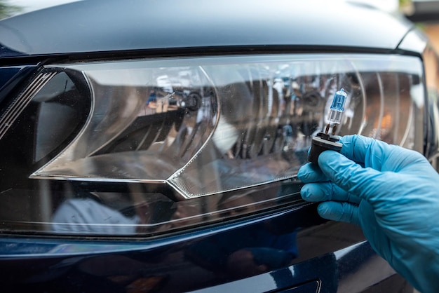 Photo man holding bulb for repair car light