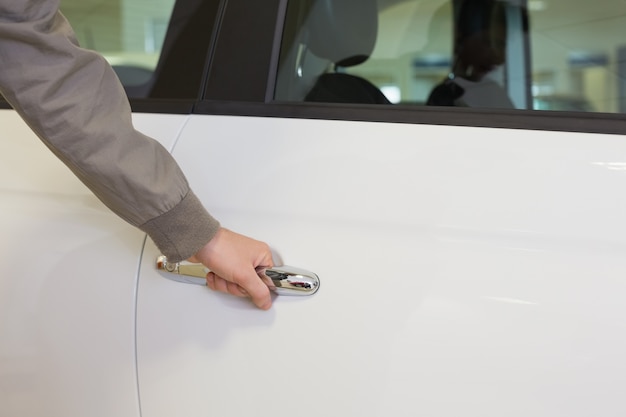 Man holding a car door handles