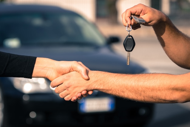 man holding car keys