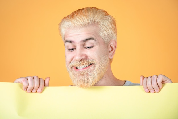 Man holding card man with banner isolated yellow background man showing empty card