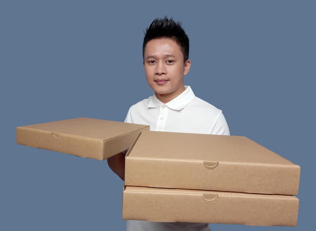 Man holding cardboard pizza box isolated on plain background