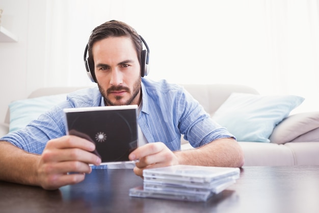 Man holding cd while listening to music