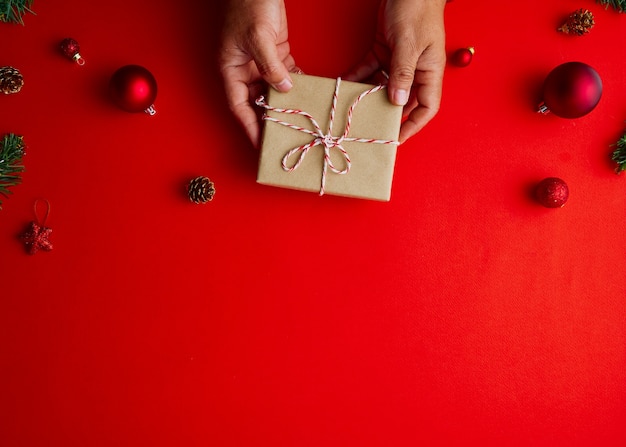 Man holding Christmas gift box with decorations