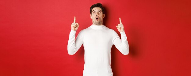 Man holding cigarette against red background