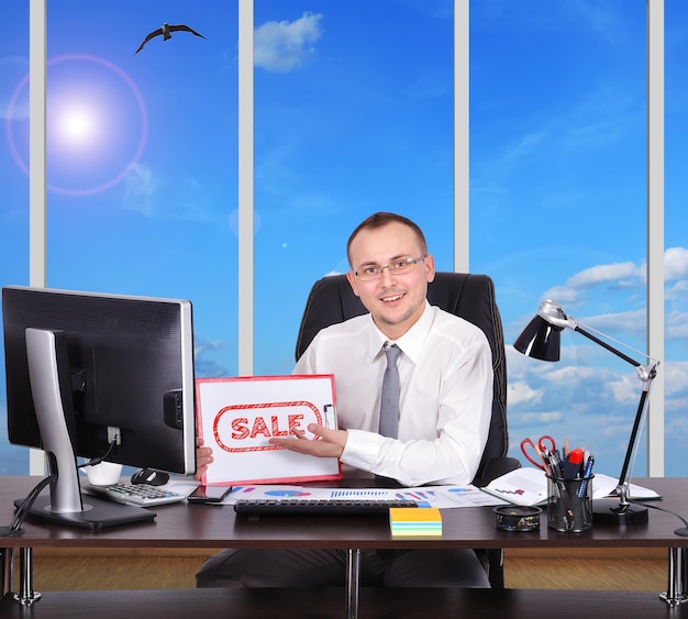 Man holding clipboard with sale