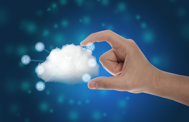 Photo man holding cloud with icons on blue background closeup modern technology