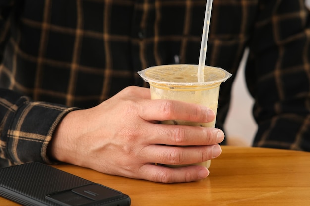 Man holding coffee cup at cafetaria