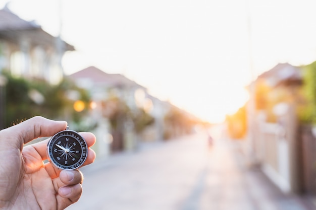 Man holding compass on blurred background. for activity lifestyle outdoors freedom or travel tourism and inspiration backpacker alone tourist travel or navigator image.