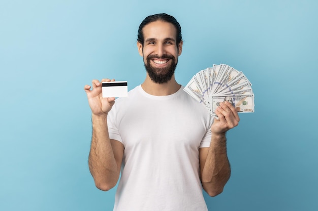 Man holding credit card and dollar banknotes feeling rich with lot of money happy to get bank loan