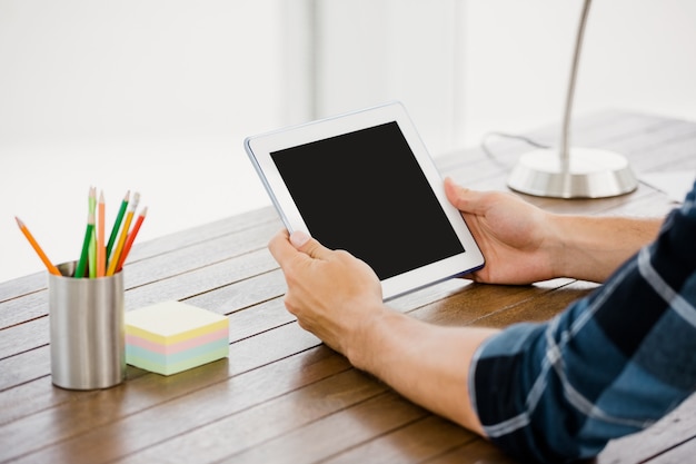 Man holding digital at his desk