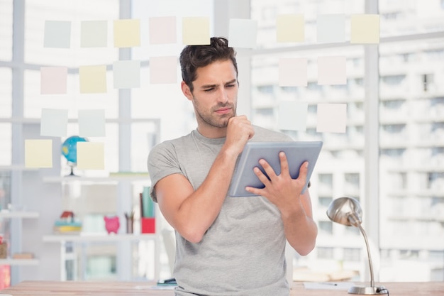 Man holding digital tablet and sticky notes