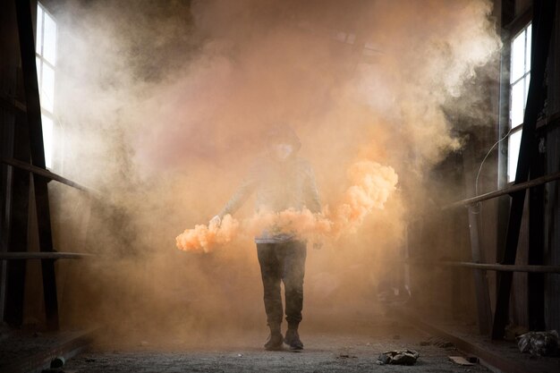 man holding distress flare while walking in corridor