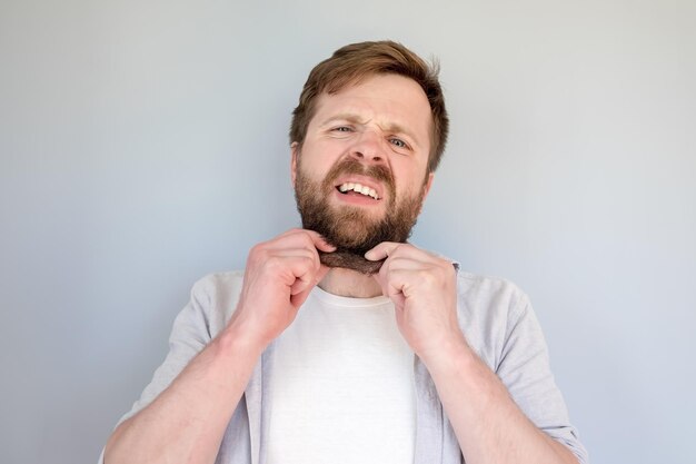 Man holding double chin in his hands he is very upset about obesity and overweight