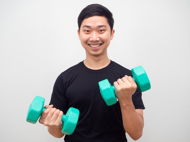 Man holding drumbbell with happy smile motivation workout concept