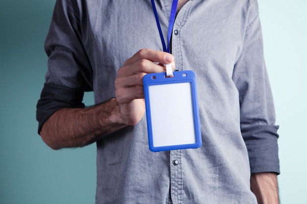 A man holding an employee ID tag