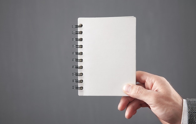 Man holding empty notepad. Space for your text