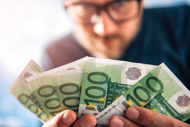 Man Holding European Money