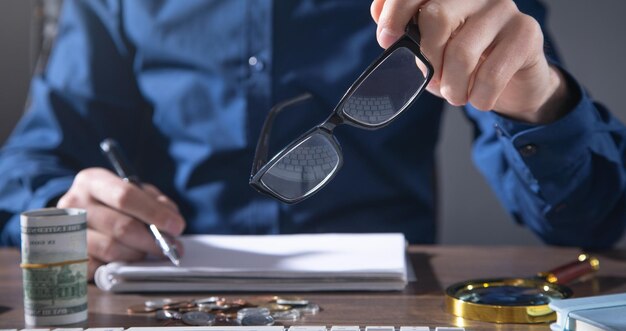 Man holding eyeglasses at office