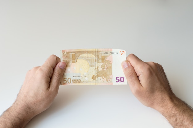 Photo man holding fifty  euro banknote in his hands