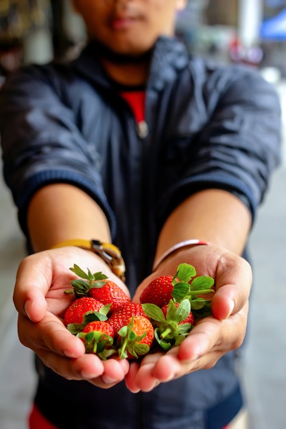 A Man Holding Fresh Strawberries