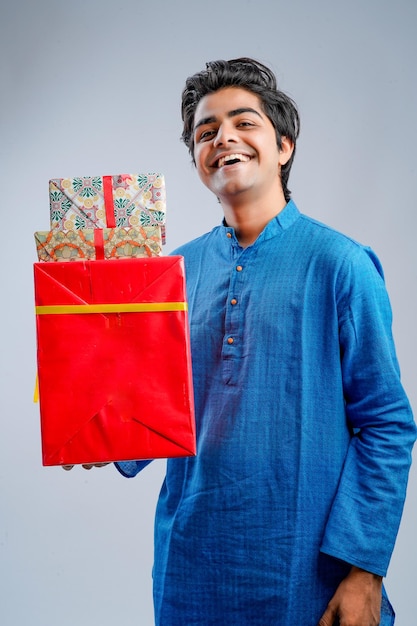 Man holding gift boxes and lamp during Diwali festival