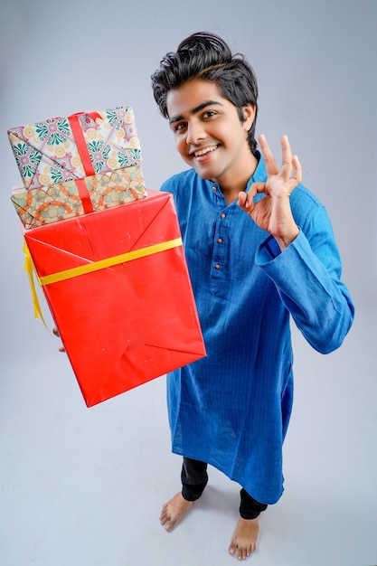 Man holding gift boxes and lamp during Diwali festival