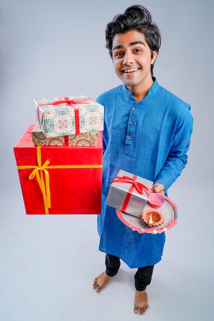 Man holding gift boxes and lamp during Diwali festival