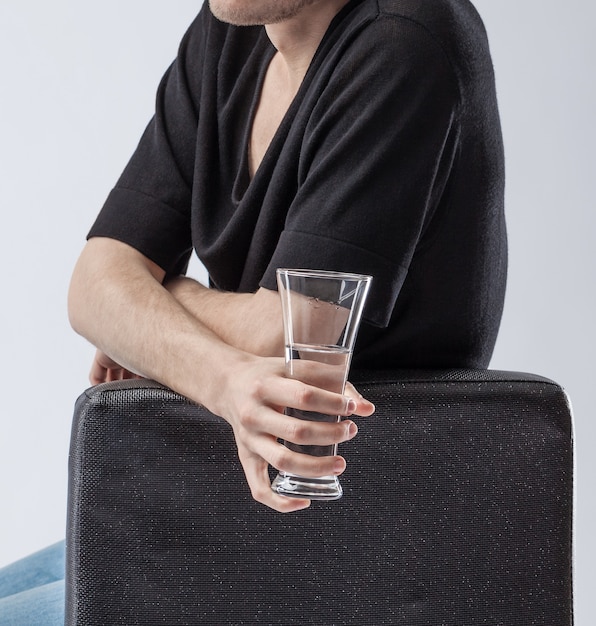 Man holding a glass of clean drinking water.