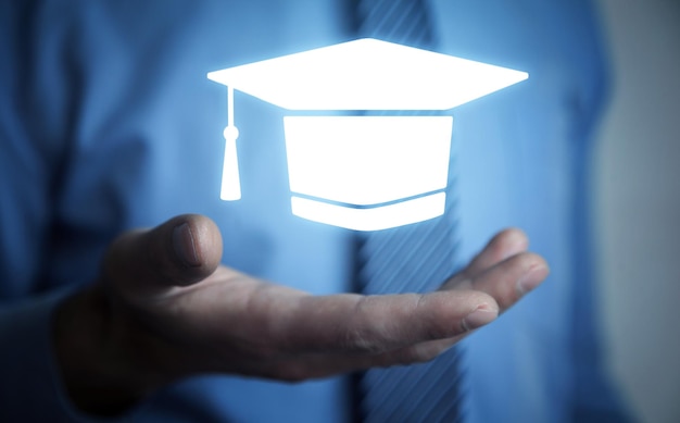 Man holding graduation cap symbol Education