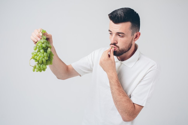 Man holding grape, close up. concept. isolated on white