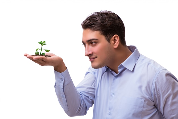 Man holding green seedling isolated on white