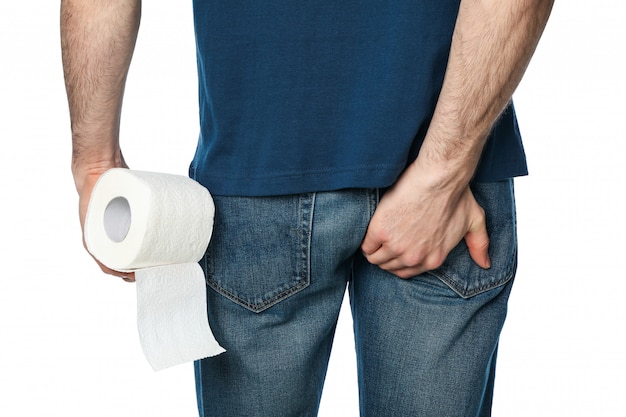 Man holding his butt and toilet paper, isolated on white