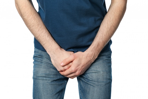 Man holding his groin, isolated on white. Men's health