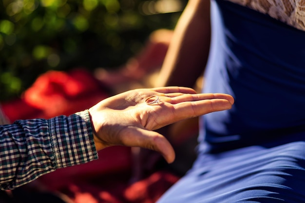 Photo man holding in his hand a ring as marriage proposal