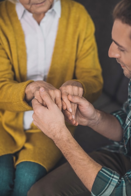 Photo man holding his mom hands with love