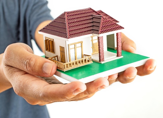 Man holding house model