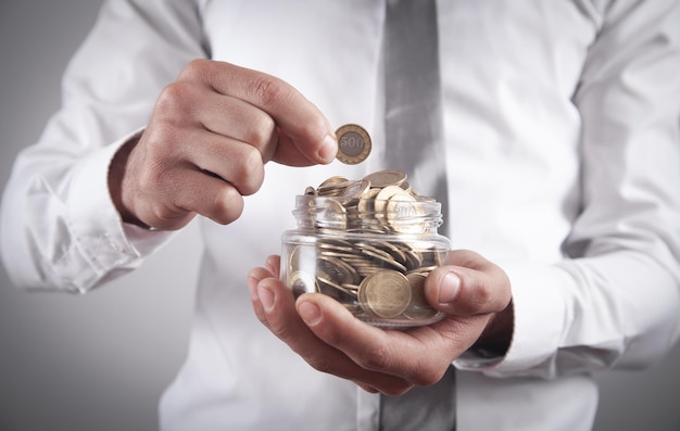 Man holding jar of coins