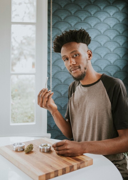 A man holding a joint in hand