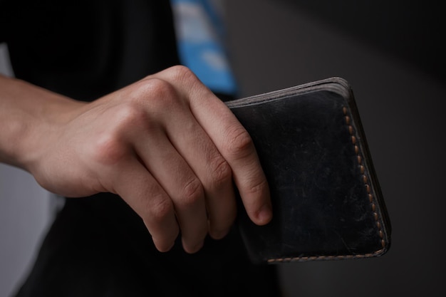 Man holding a leather wallet